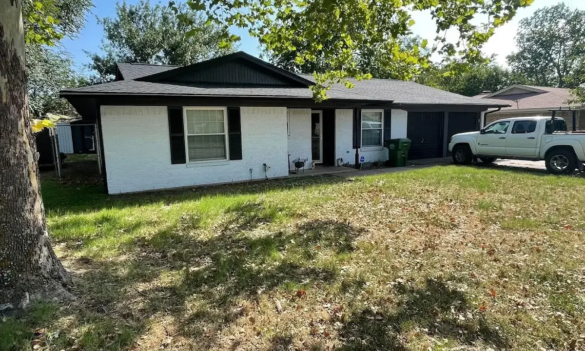 Professional roofing crew working on a residential roof in Mead